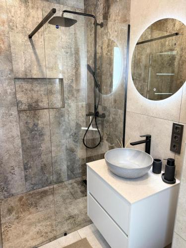 a bathroom with a sink and a shower at Riverside Cottage in Palanga