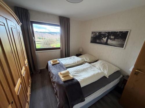 a bedroom with a bed with two towels on it at Haus Aktiv Garten2 in Winterberg