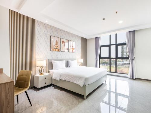 a bedroom with a bed and a desk and a chair at H Resident in Phnom Penh