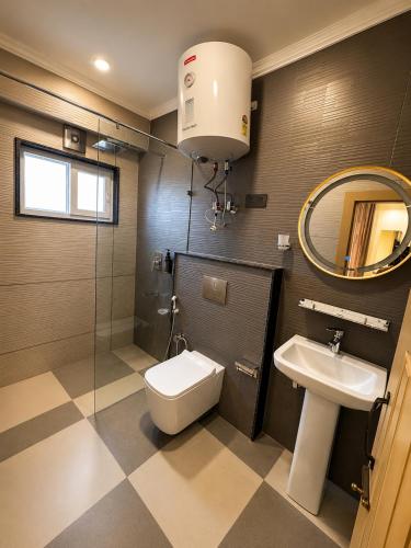 a bathroom with a toilet and a sink at Casa Grande in Srinagar