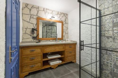 a bathroom with a sink and a mirror at Adella Garden Marina Hotel in Güvercin Adası
