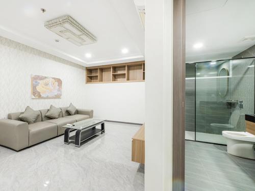 a living room with a couch and a sink at H Resident in Phnom Penh