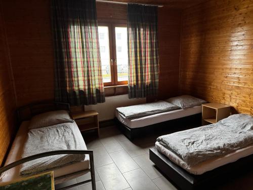 a bedroom with two beds and a window at Monteurzimmer Drei Gleichen in Günthersleben