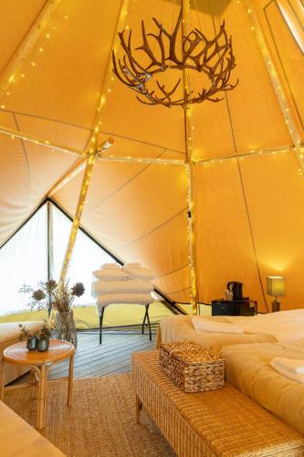 a room with a tent with two beds and a table at Camp Gielas, Arvidsjaur in Arvidsjaur