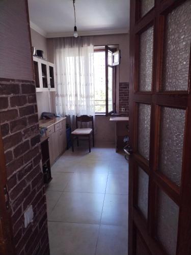 an open door to a kitchen with a brick wall at Lalo in Tbilisi City