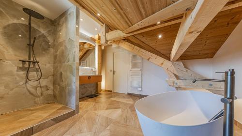 a bathroom with a shower and a large tub at Villa Panoramique - Lac du Bourget in Bourdeau
