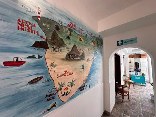 a wall with a mural of a beach at Puerto Nest Hostel in Puerto de la Cruz