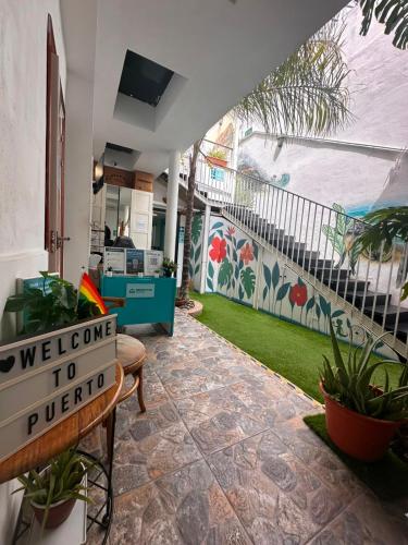 a welcome to troia sign in the lobby of a house at Puerto Nest Hostel in Puerto de la Cruz