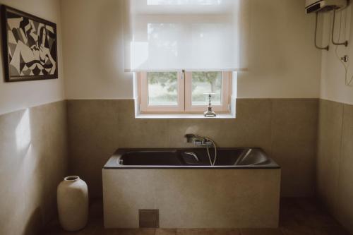 a kitchen with a sink and a window at Nizija in Sombor