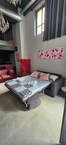 a room with a bed and a couch in it at Loft Deluxe centralissimo-Antica Vetreria in San Benedetto del Tronto
