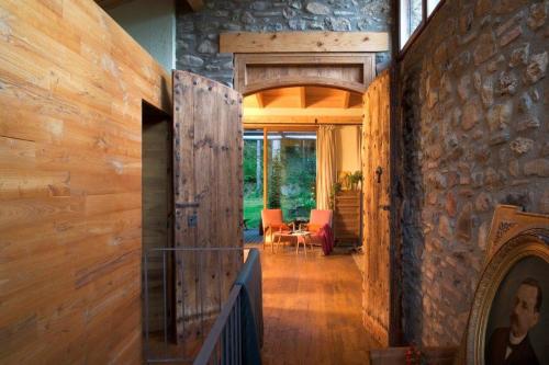 a hallway of a house with a stone wall at La Farga de la Muga in Sant Llorenç de la Muga