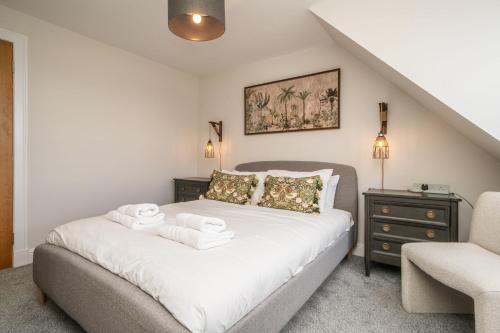 a bedroom with a bed with towels on it at A beautiful mews house in a city centre in Edinburgh