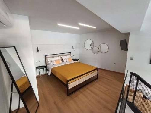 a bedroom with a bed in a white room at Alkaiou Loft in Kalamata