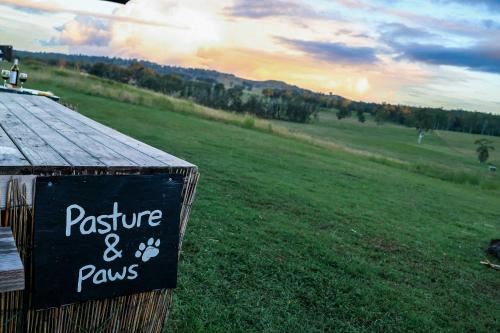 a sign that says pasture and paws on a field at Pasture and Paws by Tiny Away in Leeville