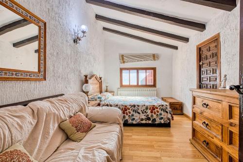 a living room with a couch and a bedroom at La Adrada Green Escape with pool in La Adrada