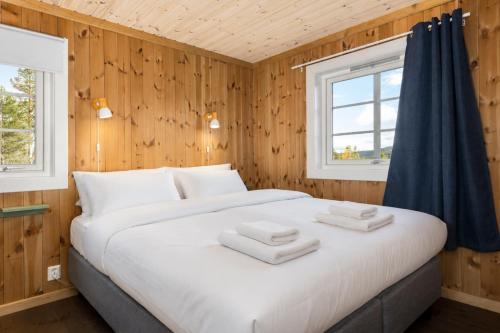a bedroom with a large bed with towels on it at Unique mountain retreat in Gol in Gol