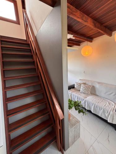 a staircase leading up to a room with a bed at Casa Bouganville in Monte das Gameleiras