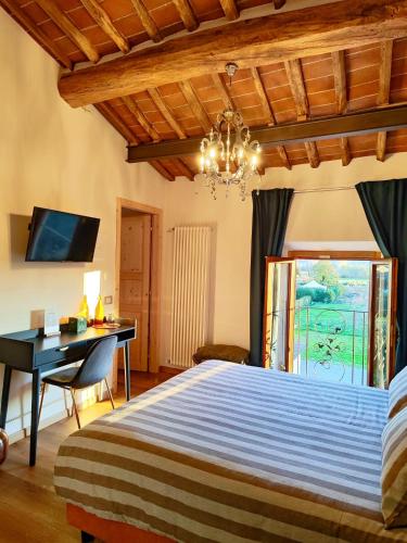 a bedroom with a bed and a desk and a window at B&B Toringo in Capannori
