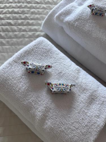 a group of towels with embroidered animals on them at Sun&Sea in Jastarnia
