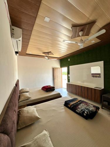a living room with a couch and a ceiling at The Empire Hotel in Sewāni