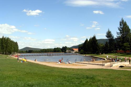 a group of people on a beach near a lake at Chalupa u Broumovských stěn in Božanov