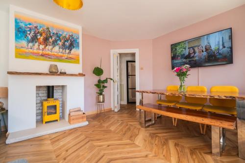 a living room with a fireplace and a tv on the wall at Beach Cottage Pets Welcome Sleeps 6 in Broadstairs