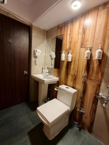 a bathroom with a toilet and a sink at Teesta Hotels, Kalimpong in Kalimpong