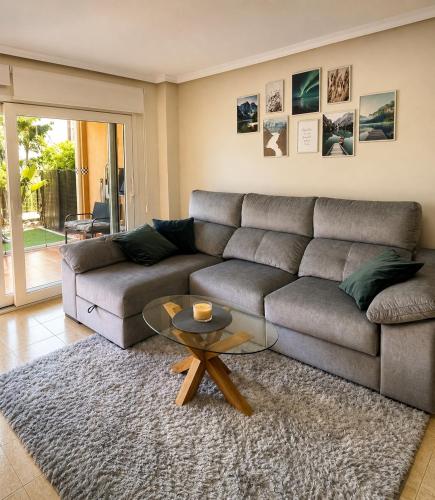 a living room with a couch and a table at Bungalow with Pool & BBQ - Carabassi Beach 10' in Gran Alacant