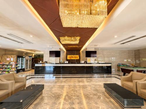 a lobby of a hotel with a bar and chairs at Avana Laem Chabang Boutique Hotel in Ban Laem Chabang