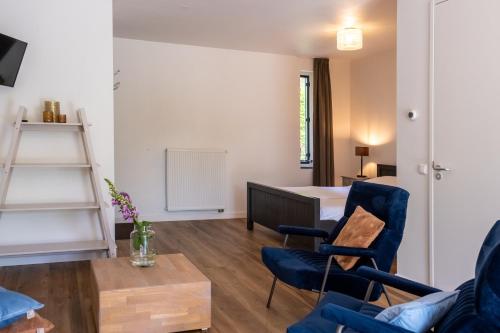 a living room with a bed and a table and chairs at ParelDuyn in Oostkapelle