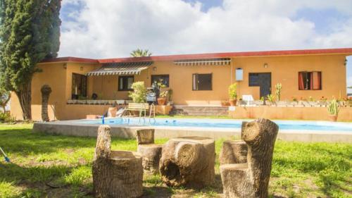 a house with a pool in front of it at Guayaba Hostel in Las Lagunas
