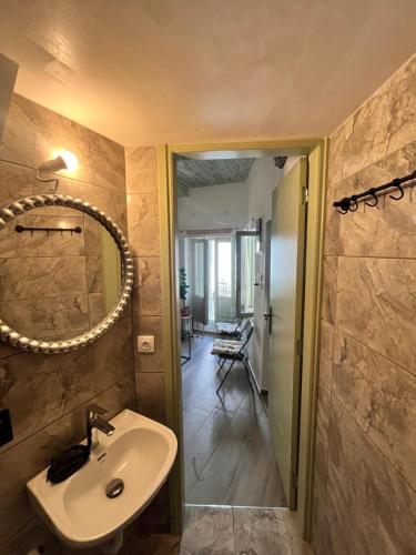 a bathroom with a sink and a mirror at Happiness skopelos in Glossa