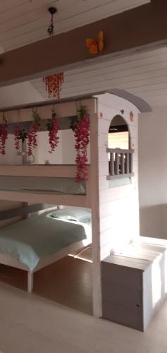 a play house with a bed in a room at Fenêtre sur Loire in Iguerande