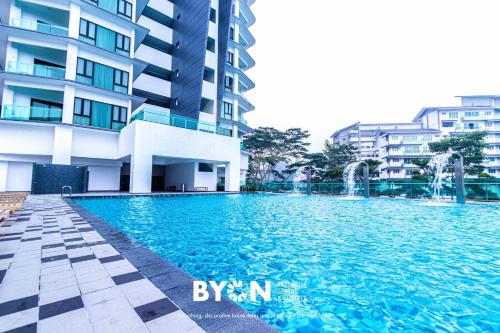 a swimming pool in front of a building at Geo38 Premium Suites Genting Highlands by BYON in Genting Highlands