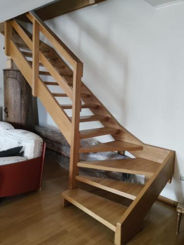 a wooden spiral staircase in a room with a bed at Leo House in Selínia