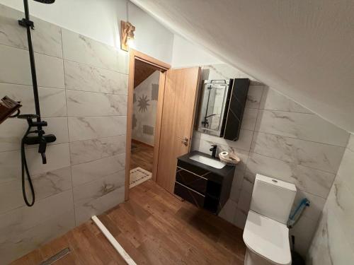 a small bathroom with a toilet and a sink at Blue Eye Villas in Sarandë