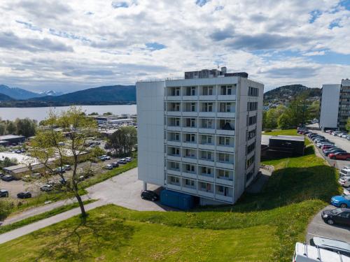 an aerial view of a white building with a parking lot at A11 Apartments in Ålesund