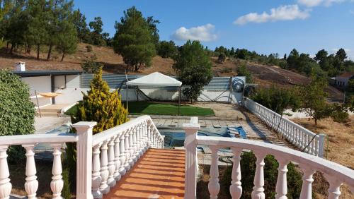 a white staircase leading to a house with a gazebo at cupido feeling nomad in Souro Pires