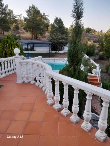 a white railing next to a swimming pool at cupido feeling nomad in Souro Pires