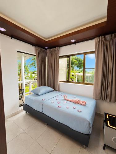 a bedroom with a bed with a phone on it at Villa Giacomelli Samui in Taling Ngam Beach