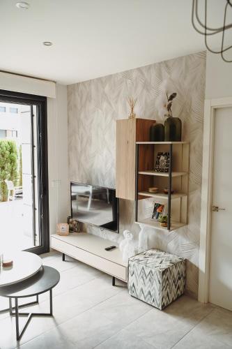 a living room with a couch and a table at Xava Dreams Aire in Villacosta