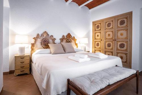 a bedroom with a large white bed with two pillows at Torre Sant Genís in Llança