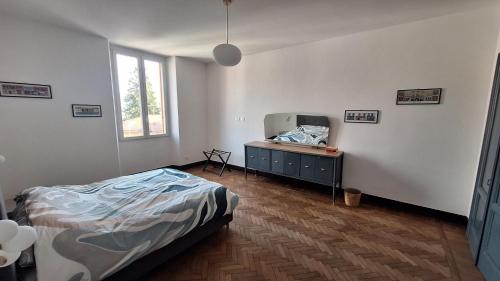 a bedroom with a bed and a dresser and a tv at Casa Tatta - Luino centro in Luino