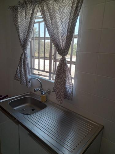 a sink and a window in a bathroom at M's guest place Nata in Nata