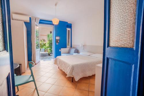 a room with a bed and a blue door with a bedroom at Soffio Di Mare in Camogli