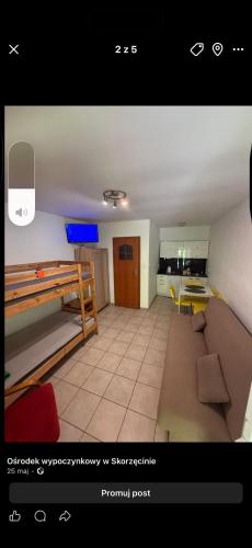 a living room with a couch and a kitchen at Ośmiorniczka Skorzęcin in Skorzęcin