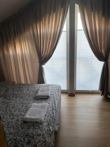 a bedroom with a bed and a large window at TINY HOUSE domek do wynajęcia in Olsztyn