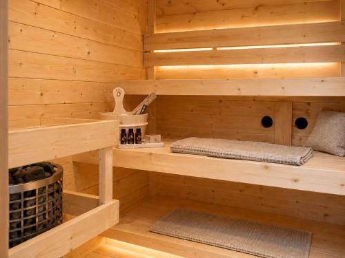 a sauna with wooden walls and wooden shelves at Steam & Dream - Hottub & Sauna Retreat - Free WiFi - Full Privacy - Luxury Experience in Heinkensand