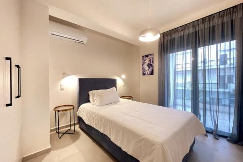a bedroom with a bed and a large window at Athenean Gem Near Metro Mall in Athens