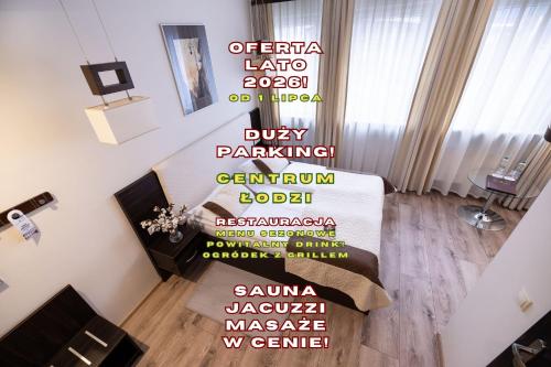 a living room with a staircase with a wall with words at Hotel Borowiecki in Łódź